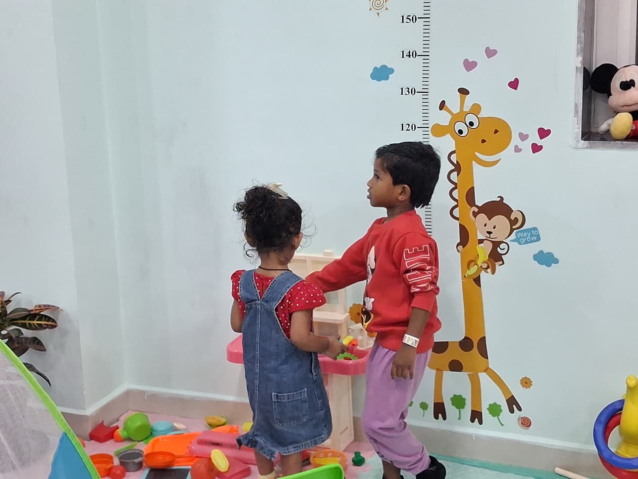 Children exploring a colorful play corner at Cocomelos